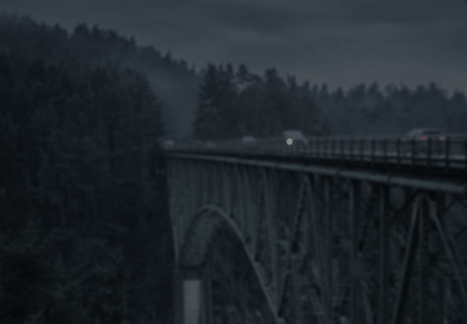 A foggy bridge with cars