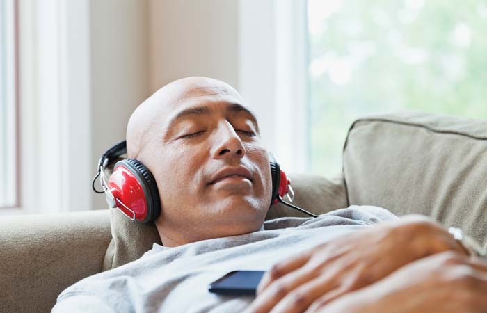 Man with headphones relaxing on a couch
