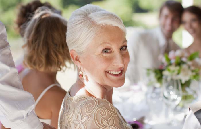 older woman smiling at a wedding